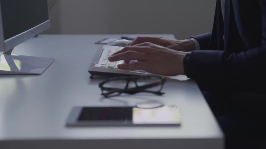 A person types on a keyboard