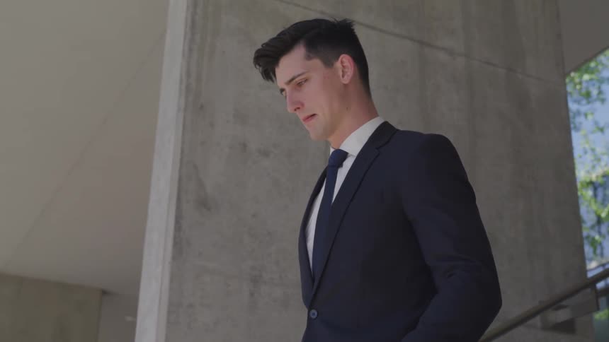 A man walks down an outdoor flight of stairs