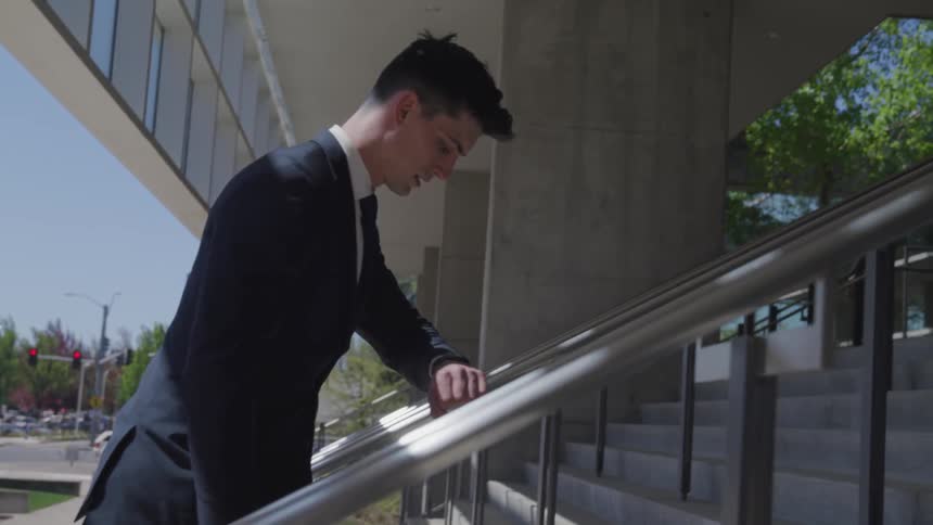 A businessman walking up steps