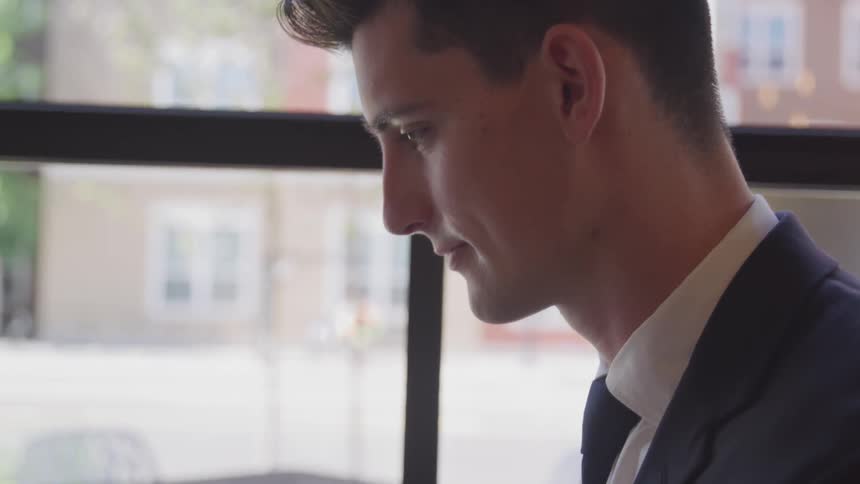 A man wearing a suit works inside a building