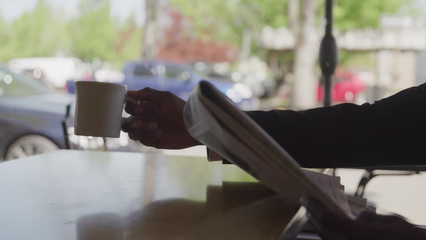 A man with suit drink a cup of coffee