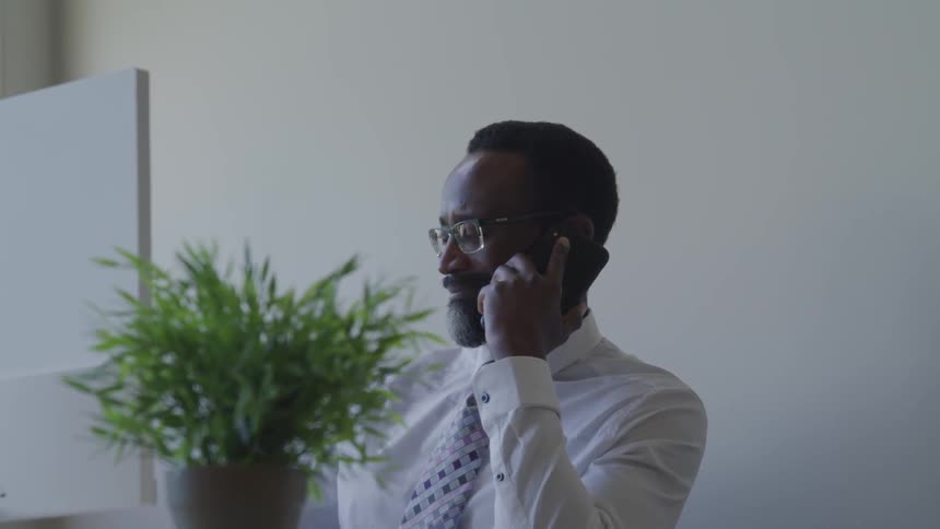 A black man talking on the phone