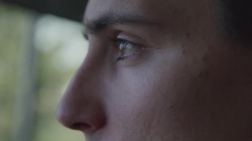 Close up of a young mans face as he looks in to the distance