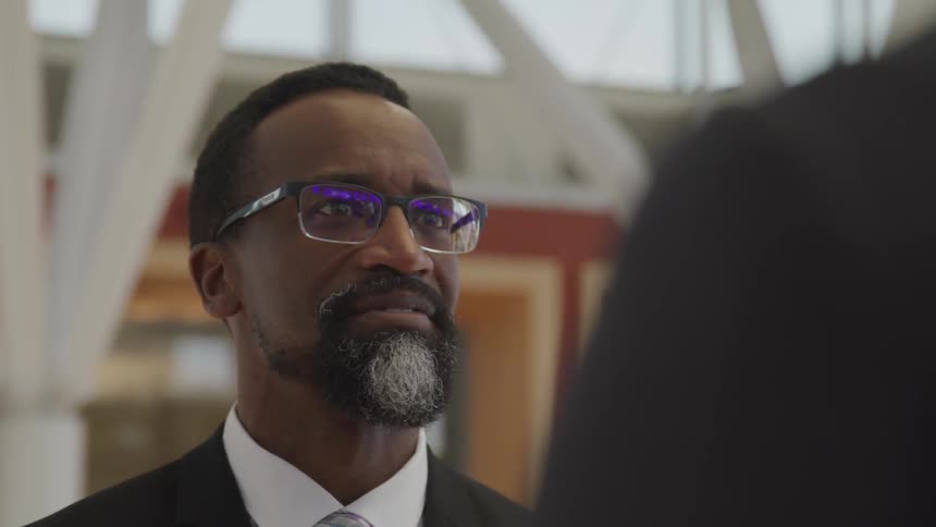 Black businessman talks to the white businessman in the office
