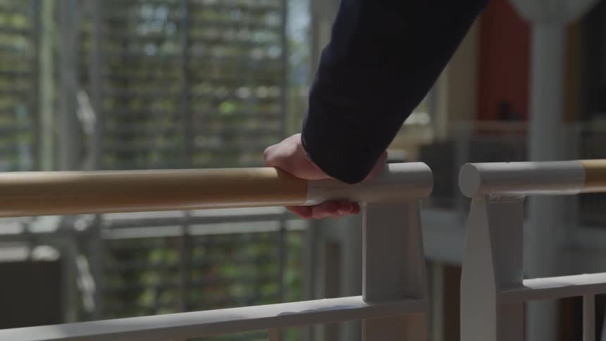Man holding into the rails