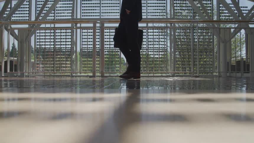 A man in a suit walks through a building