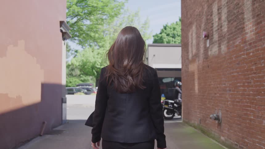 Female with suit walks in the downtown