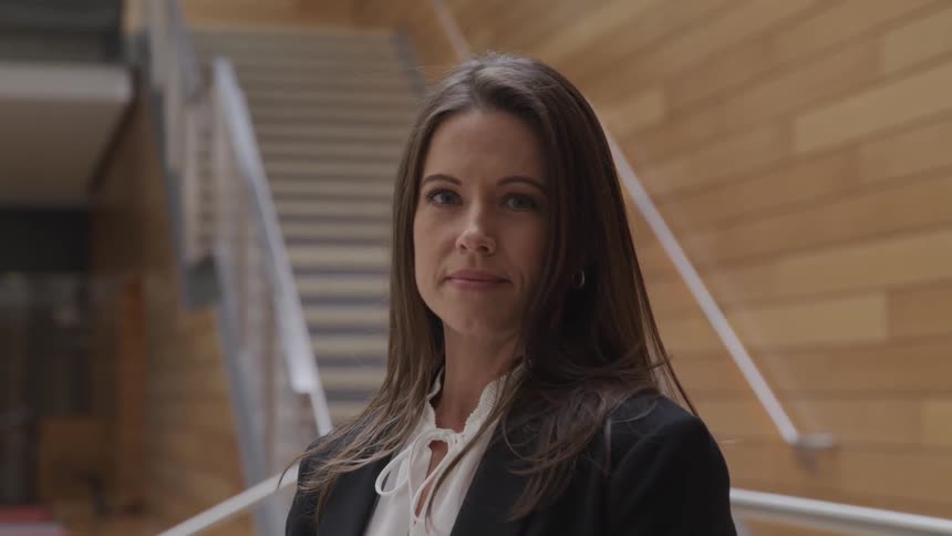 A woman is standing in a building