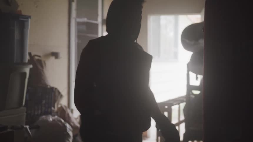 A man walks past the heavy bag in the room