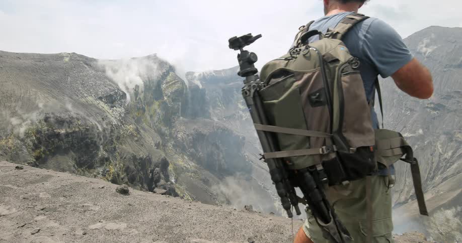 Man takes pictures of smoking crater,