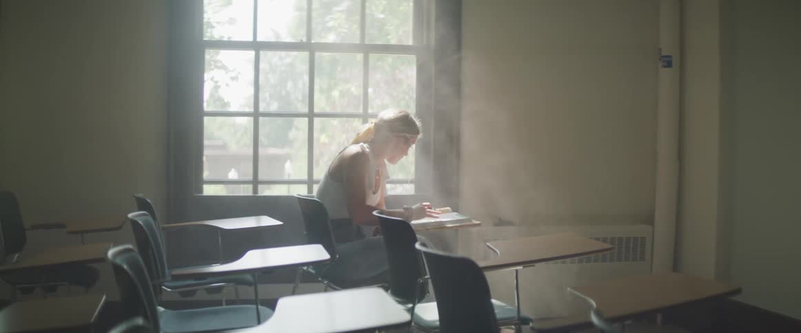 Woman studying near foggy glass