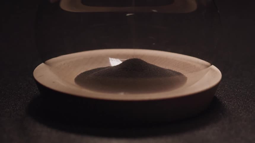 An hourglass in the dark light