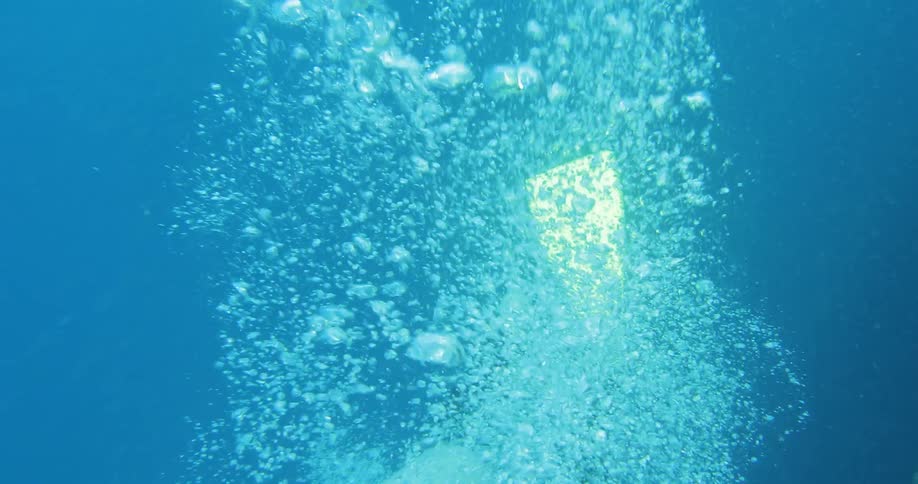 A man scuba diving with a bright light