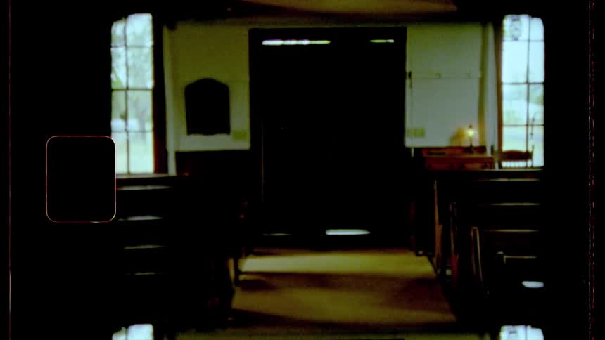 The closed door and empty pews of a church