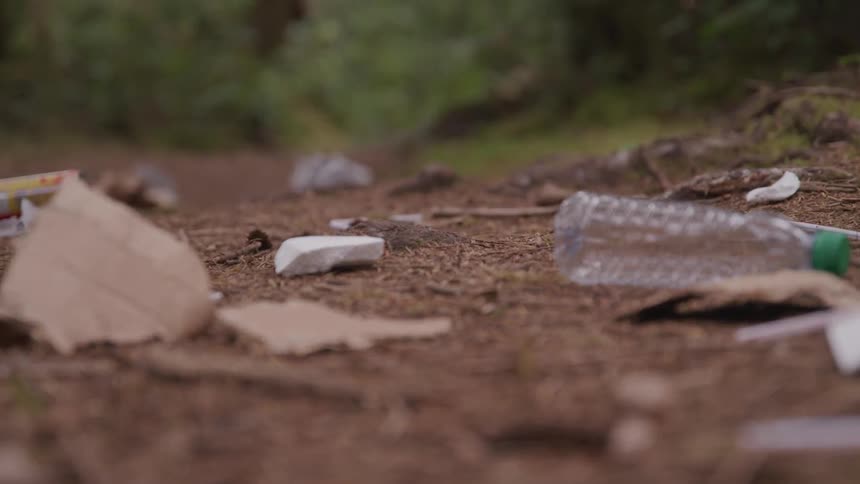 A close up view of soil full of trash