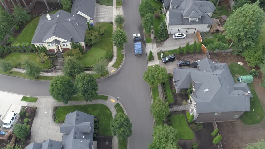 A car is driving through a neighborhood