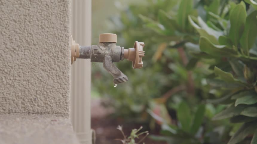 A footage of an outdoor faucet dropping water