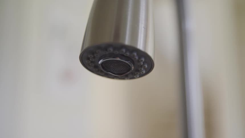 Water droplets from a faucet
