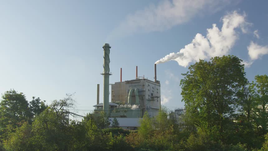 Smoke billows out of a factory chimney