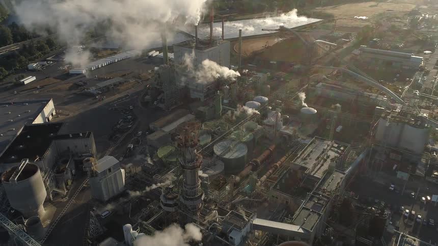 The site is filled with buildings giving off smoke