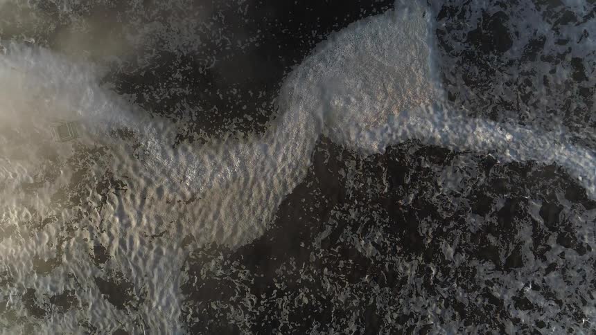 An aerial view of a water ripple n the ocean