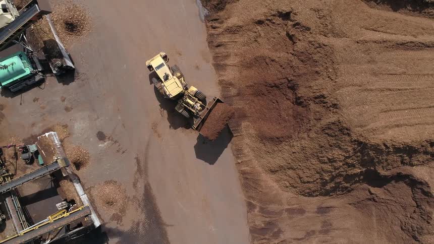 Birds eye view of a tractor lifting dirt at a construction site