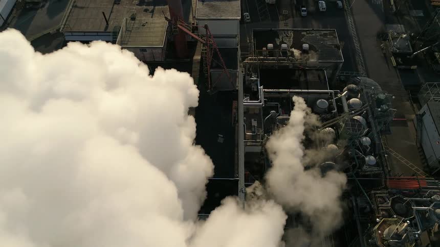 The smoke rises from the factory