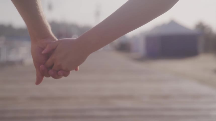 Couple holding hands together