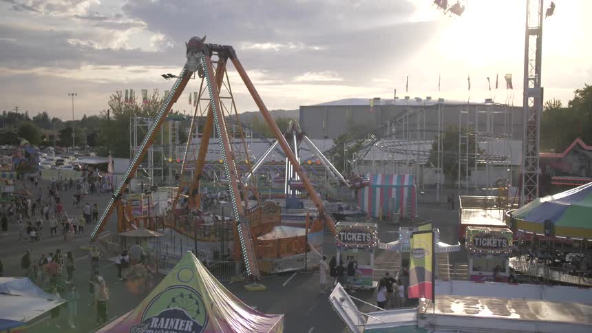 People are walking around the carnival during the day