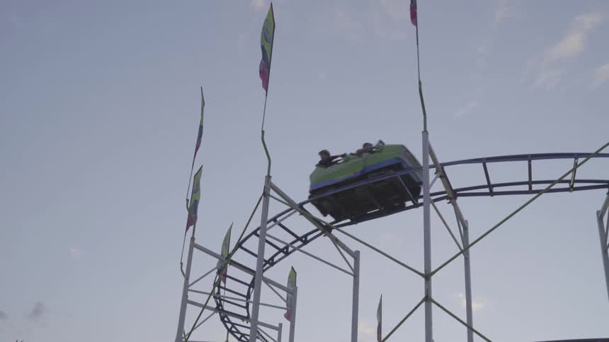 A footage of a roller coaster at the amusement park
