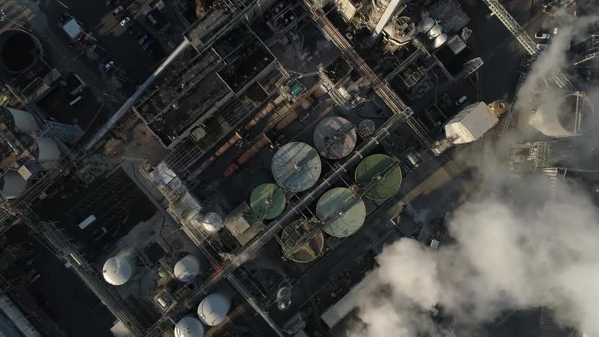 Smoke rises from containers in an industrial area
