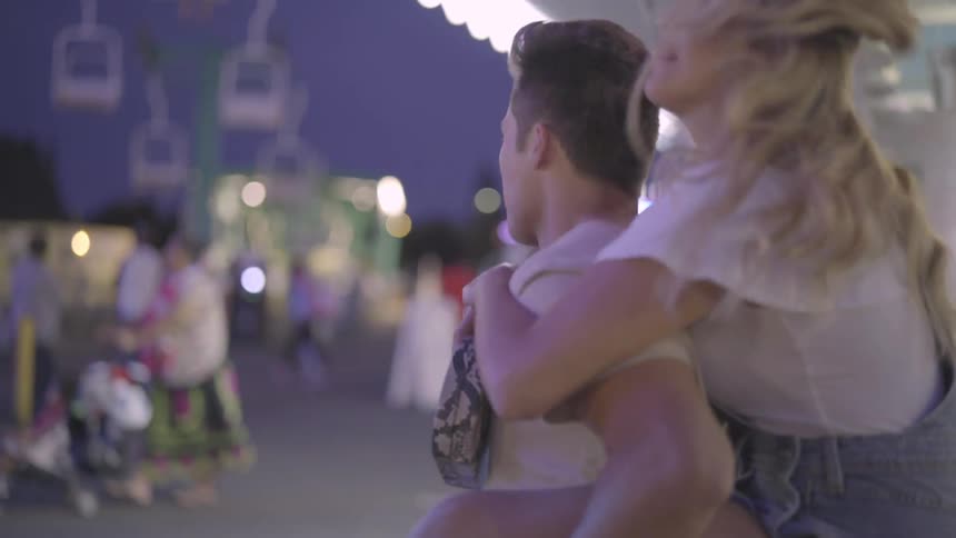 People travel around the carnival at sunset