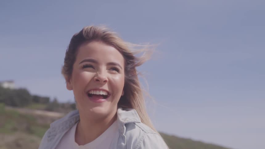 A woman and man are outdoors laughing