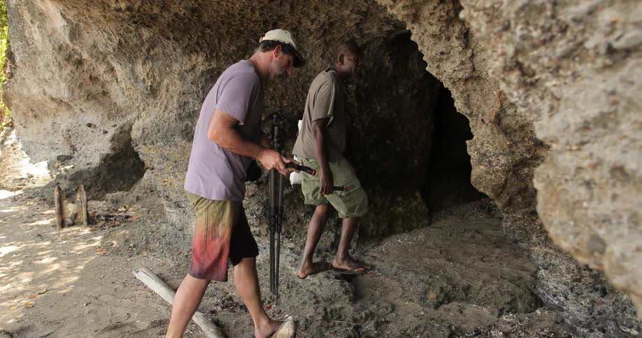 Men enter a cave