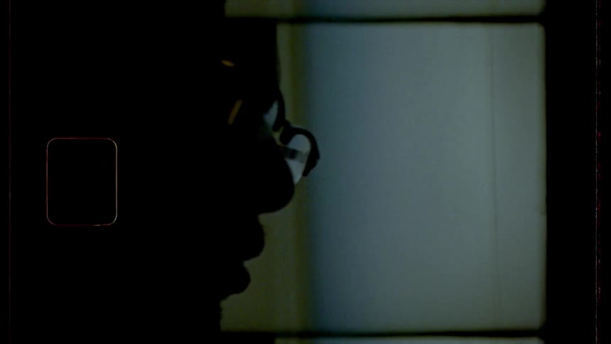 A silhouette of a man with glass working