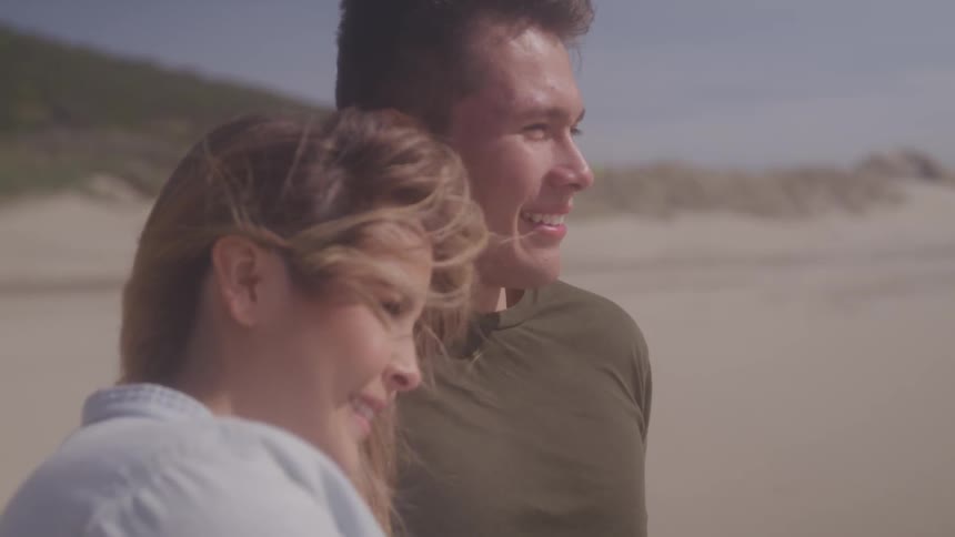 Couple standing in the beach on the windy days
