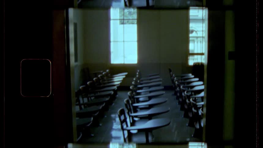 Rows of empty desks in empty classroom during the day