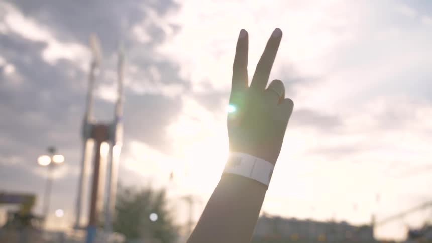 A person puts up the peace sign