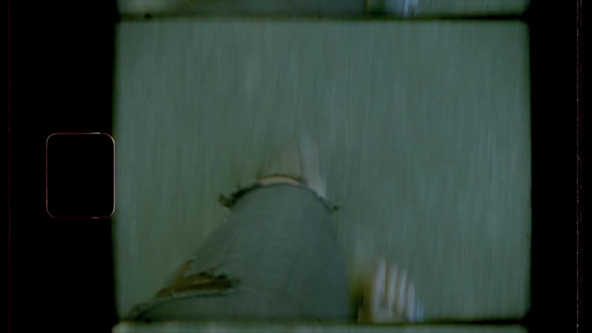 A vintage footage of a leg of a person walking