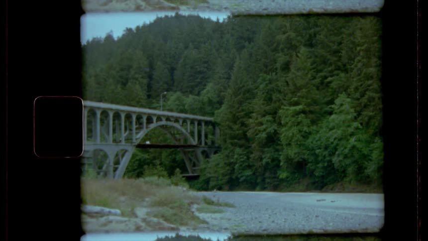 A vintage footage of a bridge on the river