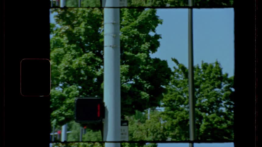 Attached to a utility pole a crosswalk indicator with timer counts down and blinks and image of a red hand