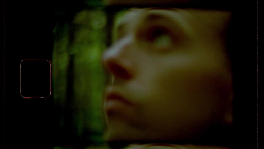 Film footage of a man looking up in a forest