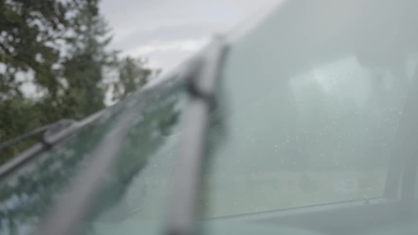 Windshield wipers move back and forth on a dry windshield