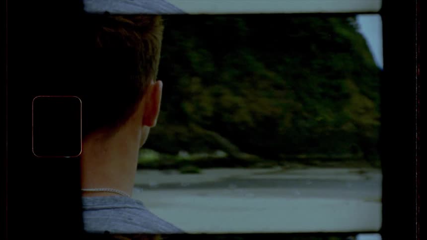 Film footage of a male in front of the waterfront