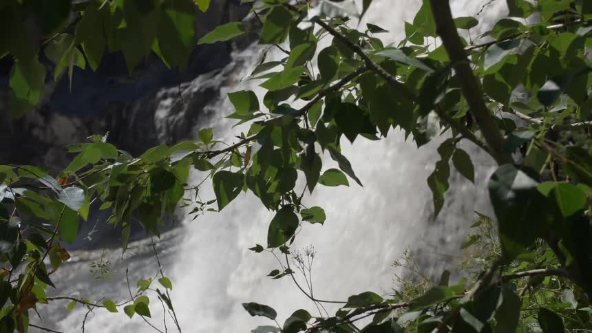 The waterfall rages over the creek