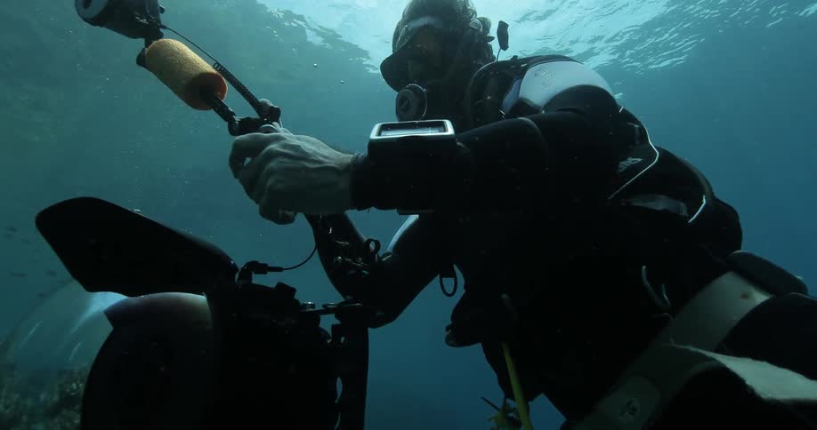 A diver uses equipment underwater