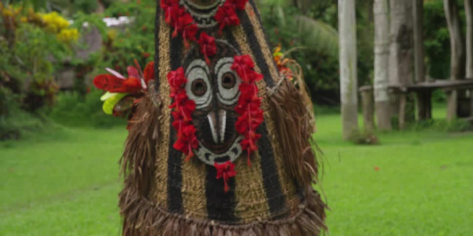 A person dances in a native costume