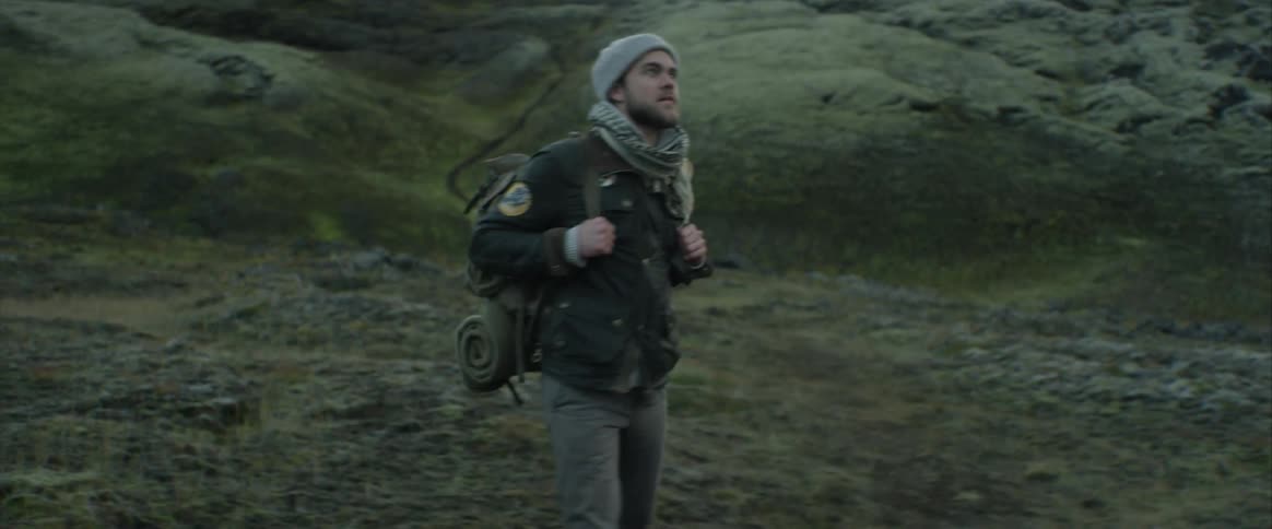 A hiker in the mountains during the day
