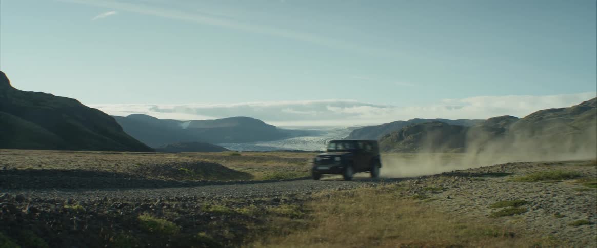 A jeep car driving at the meadow