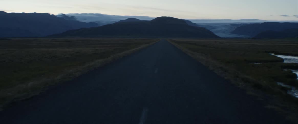 A road through a countryside during the day